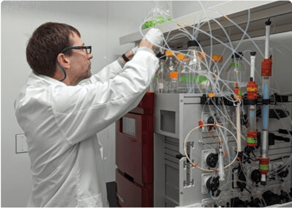 Researcher adjusting lab apparatus