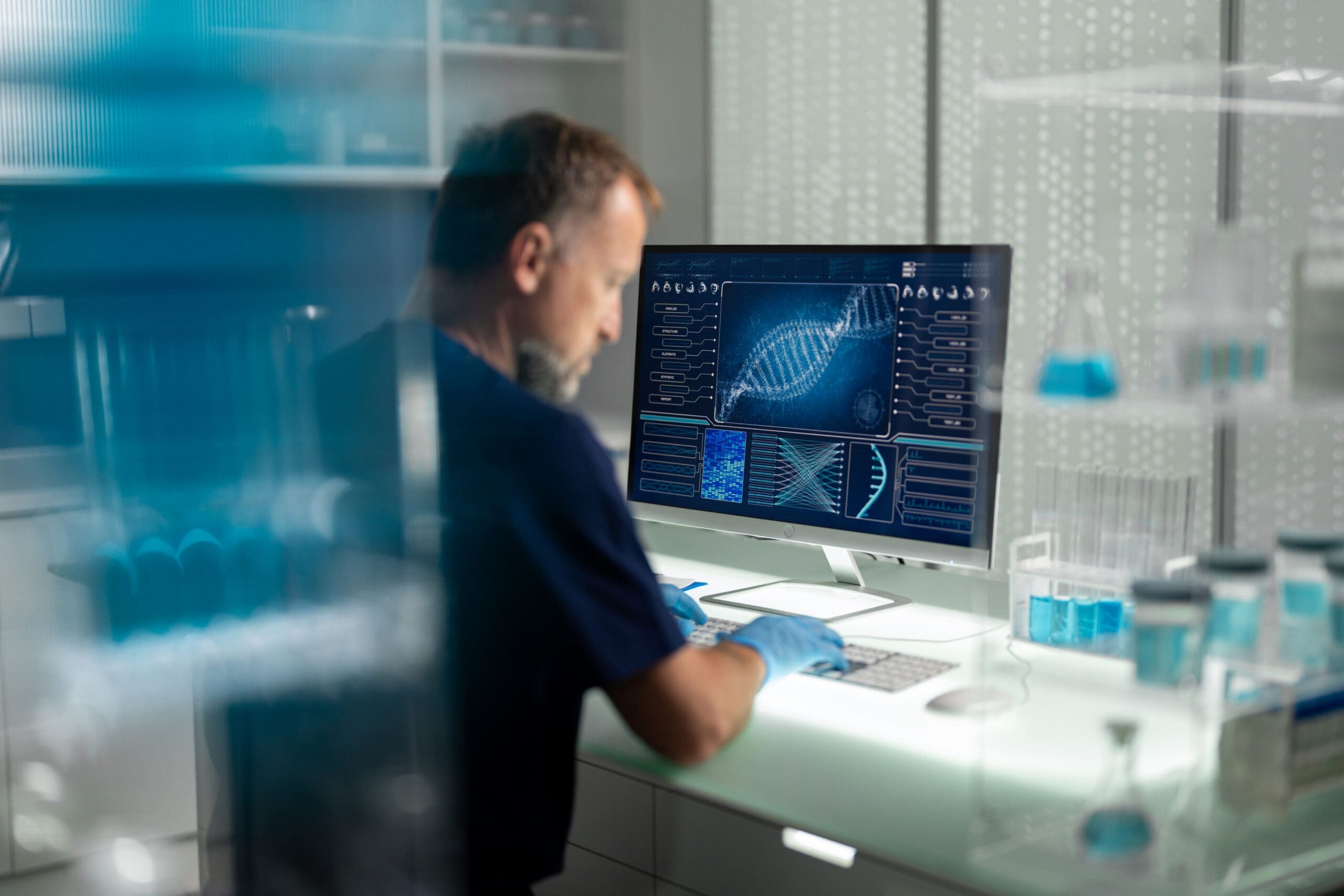 Scientist analyzing DNA on computer