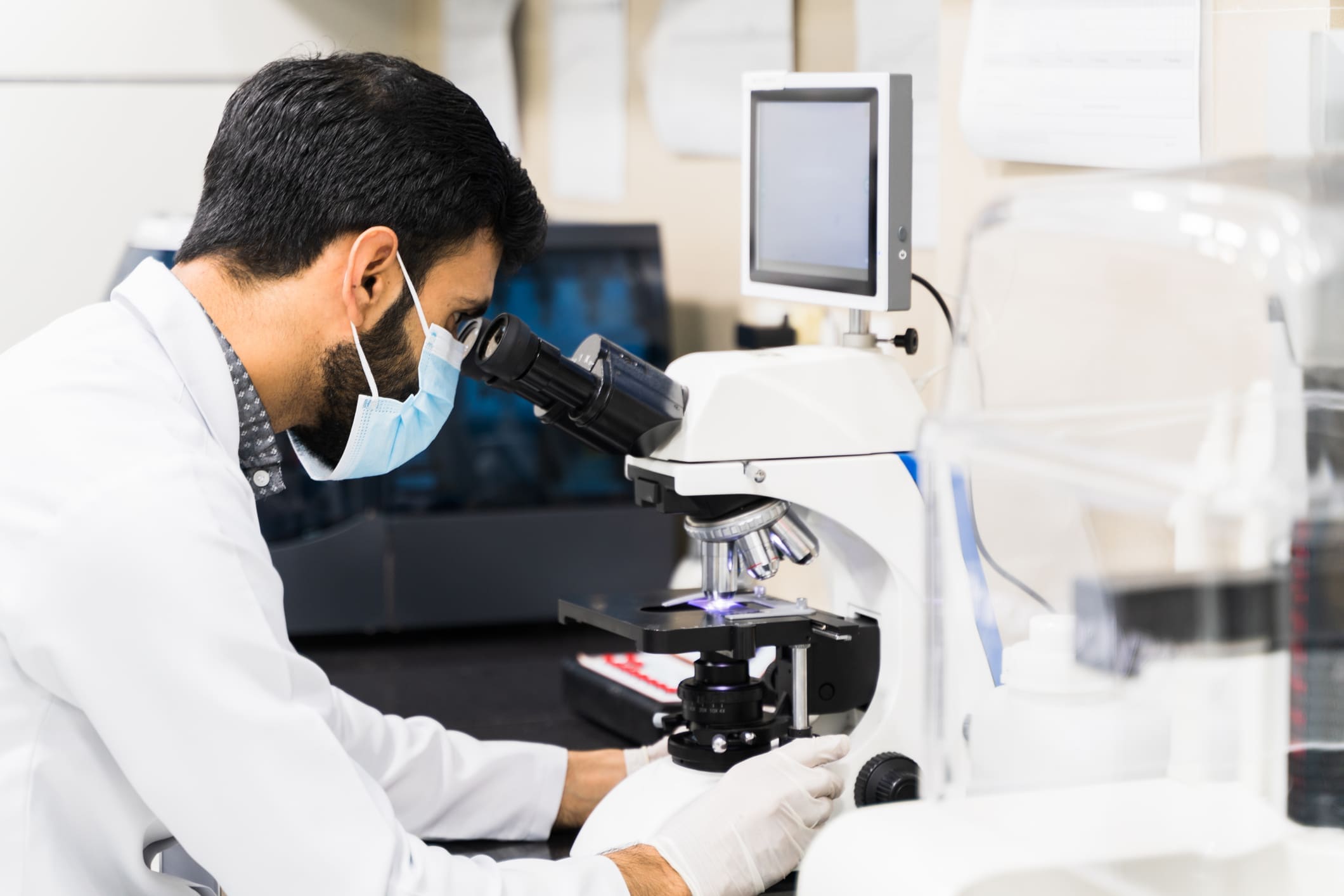Lab technician analyzing specimen slides