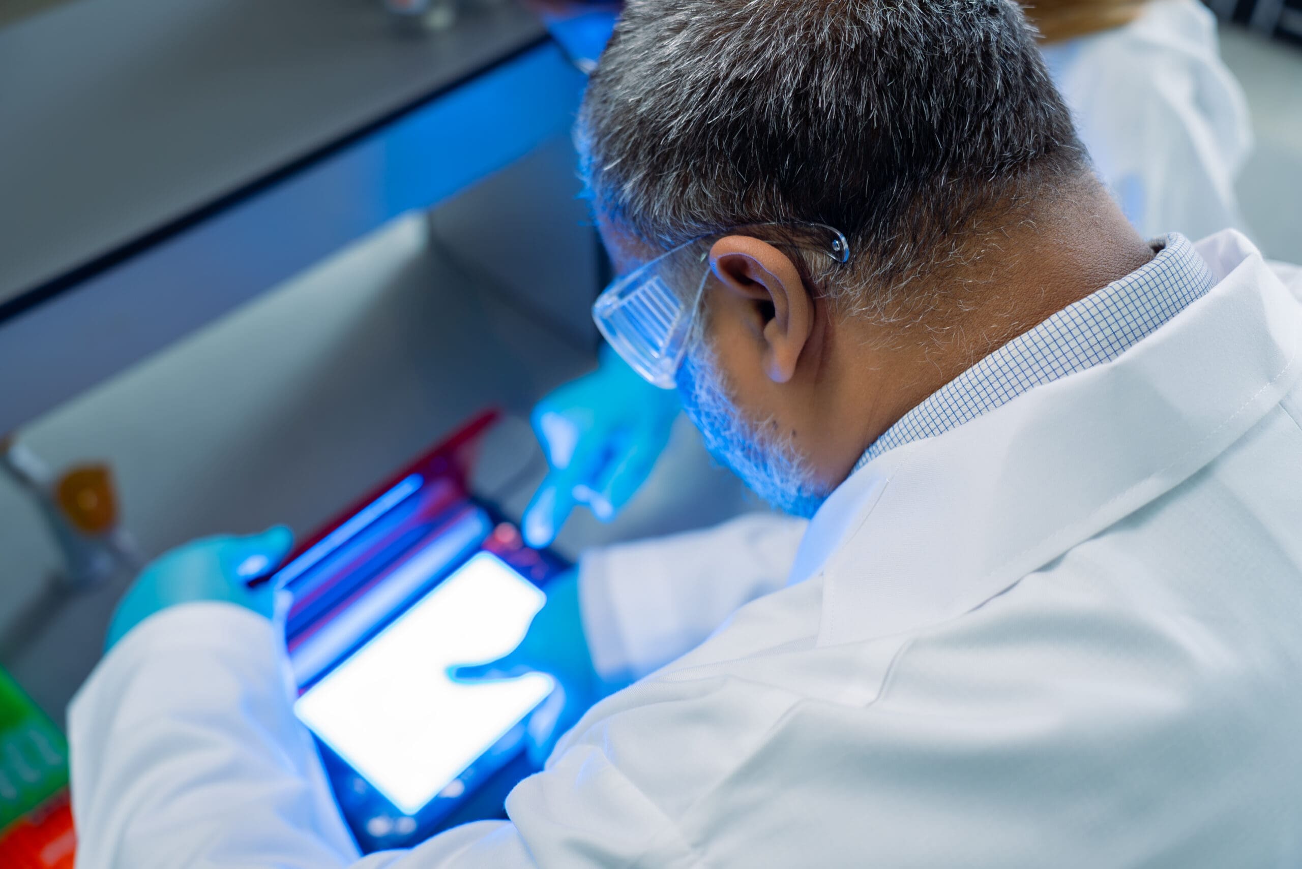 Researcher in laboratory with tablet