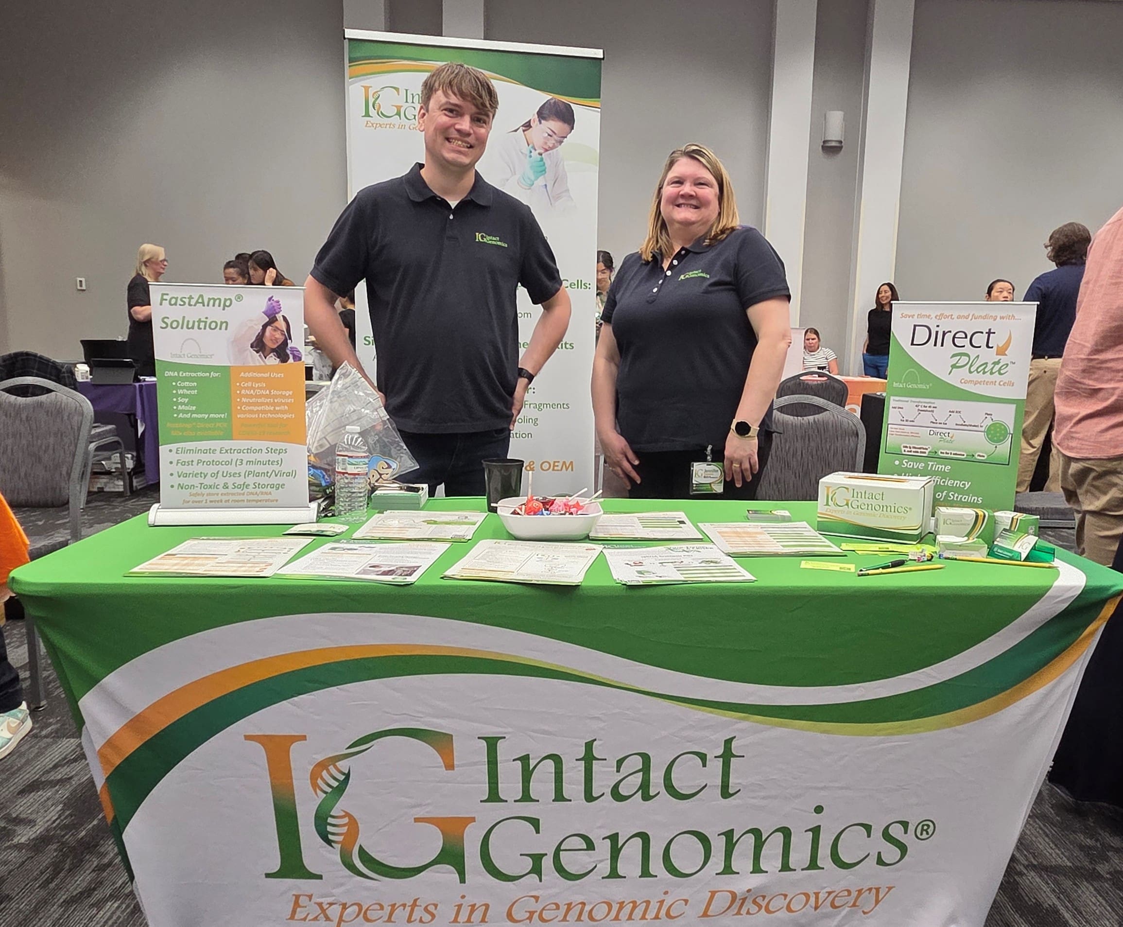 Two people at Intact Genomics display table